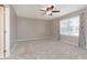 Bedroom with carpet flooring, ceiling fan, large windows, and natural light at 1325 E 47Th St, Anderson, IN 46013