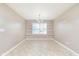 Bright dining room with tile floors, chandelier, white trim, and a window at 1325 E 47Th St, Anderson, IN 46013