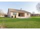 Back exterior of home with well-maintained lawn and patio at 1325 E 47Th St, Anderson, IN 46013