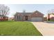 Charming brick home with well-manicured lawn and a two-car garage at 1325 E 47Th St, Anderson, IN 46013