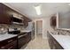 Well-lit kitchen with stainless steel appliances, ample counter space, and sleek finishes at 1325 E 47Th St, Anderson, IN 46013