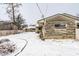 Stone exterior detailing and fenced backyard covered in snow during winter season at 1401 Castle Ave, Indianapolis, IN 46227