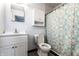 Cozy bathroom featuring a white vanity and a toilet with a decorative shower curtain at 1401 Castle Ave, Indianapolis, IN 46227
