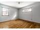 Bright bedroom with hardwood floors and two windows offering plenty of natural light at 1401 Castle Ave, Indianapolis, IN 46227