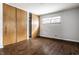 Cozy bedroom featuring two windows and a closet with sliding doors at 1401 Castle Ave, Indianapolis, IN 46227