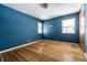 Bright bedroom with hardwood floors and two windows providing natural light at 1401 Castle Ave, Indianapolis, IN 46227