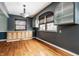 Bright dining room featuring hardwood floors, arched shelving, and a modern light fixture at 1401 Castle Ave, Indianapolis, IN 46227