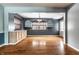 Spacious dining room featuring hardwood floors, arched shelving, and a stylish light fixture at 1401 Castle Ave, Indianapolis, IN 46227