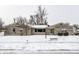 Charming single-story home with stone facade and snow-covered front yard at 1401 Castle Ave, Indianapolis, IN 46227