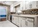 Well-lit kitchen showcasing granite counters and stainless steel dishwasher at 1401 Castle Ave, Indianapolis, IN 46227