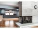 Living room featuring hardwood floors and a charming stone fireplace centerpiece at 1401 Castle Ave, Indianapolis, IN 46227