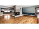 Spacious living room featuring hardwood floors, a charming stone fireplace, and natural light at 1401 Castle Ave, Indianapolis, IN 46227