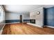 Spacious living room with hardwood floors and a charming stone fireplace centerpiece at 1401 Castle Ave, Indianapolis, IN 46227