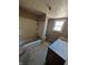 Outdated bathroom with a tub, toilet, sink, and window at 1610 Central Ave, Anderson, IN 46016