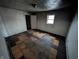 Cozy bedroom with a window providing soft natural light, ready to be refreshed at 1610 Central Ave, Anderson, IN 46016