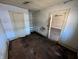 Bedroom space ready for a refresh, featuring hardwood floors, closet, and natural light at 1610 Central Ave, Anderson, IN 46016