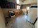Classic kitchen featuring cabinets, sink, stove, and view into the rest of the home at 1610 Central Ave, Anderson, IN 46016