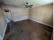 Spacious living room ready for renovation with ceiling fan, natural light, and potential at 1610 Central Ave, Anderson, IN 46016