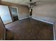 View of a well lit living room featuring hardwood floors and walls awaiting new paint at 1610 Central Ave, Anderson, IN 46016