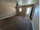Bright living room with a ceiling fan, hardwood floor, and door leading to the exterior at 1610 Central Ave, Anderson, IN 46016