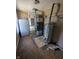 Basement area featuring a black furnace, water heater and a white refrigerator at 1628 Sherman St, Anderson, IN 46016