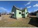 Side angled view of vintage home showing peeling paint and traditional design at 1628 Sherman St, Anderson, IN 46016