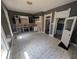 Spacious kitchen with black and white cabinets, complemented by a view to the basement at 1628 Sherman St, Anderson, IN 46016