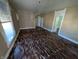 Spacious living room features original hardwood floors and abundant natural light, awaiting restoration at 1628 Sherman St, Anderson, IN 46016