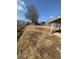 Expansive backyard with a mix of open space, mature trees, and an adjacent covered patio area at 1709 Central Ave, Anderson, IN 46016