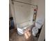 Bathroom featuring a bathtub, toilet, and colorful shower curtain at 1709 Central Ave, Anderson, IN 46016