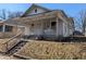 Traditional home showcasing a covered front porch and architectural details at 1709 Central Ave, Anderson, IN 46016