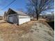 Aged detached garage with a mix of siding, offering potential for storage or renovation at 1709 Central Ave, Anderson, IN 46016