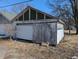 Detached garage with weathered siding, a white garage door, and visible framework detailing at 1709 Central Ave, Anderson, IN 46016