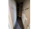 Hallway with shelves featuring peeling paint and a bare floor at 1709 Central Ave, Anderson, IN 46016