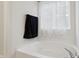 Bathroom featuring soaking tub next to window with a lace curtain at 2091 Creek Bank Dr, Columbus, IN 47201
