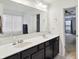 Bright bathroom with a double sink vanity and a large framed mirror at 2091 Creek Bank Dr, Columbus, IN 47201