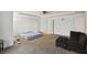 Spacious bedroom with neutral carpet, ceiling fan, and a comfortable sitting area at 2091 Creek Bank Dr, Columbus, IN 47201