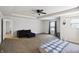 Spacious bedroom with neutral carpet, ceiling fan, and a comfortable sitting area at 2091 Creek Bank Dr, Columbus, IN 47201