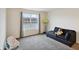 Bedroom with large window with a view of the lake, featuring a dark sofa and toys at 2091 Creek Bank Dr, Columbus, IN 47201