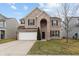 Attractive two-story brick home with a well-maintained lawn, a two car garage and curb appeal at 2091 Creek Bank Dr, Columbus, IN 47201