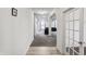 Bright hallway with hardwood flooring leading to a spacious living area and office at 2091 Creek Bank Dr, Columbus, IN 47201