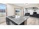 Kitchen island with dual sink overlooking the patio and adjacent living room at 2091 Creek Bank Dr, Columbus, IN 47201