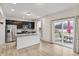 Kitchen with stainless appliances, dark cabinetry, island, and sliding doors to patio at 2091 Creek Bank Dr, Columbus, IN 47201