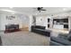 Open-concept living room with gray sofa, adjacent dining area, and view of the kitchen with dark cabinetry at 2091 Creek Bank Dr, Columbus, IN 47201