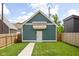 Well-maintained backyard with a lush lawn, privacy fence, and a detached garage at 2117 Broadway St, Indianapolis, IN 46202
