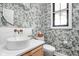 Chic powder room with floral wallpaper, a unique sink, and natural light at 2117 Broadway St, Indianapolis, IN 46202