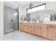 Elegant bathroom with a double vanity, quartz counters, and a modern glass-enclosed shower at 2117 Broadway St, Indianapolis, IN 46202
