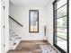 Entryway boasting wood floors, stylish rug, and stairs with patterned runner, leading to the upper level at 2117 Broadway St, Indianapolis, IN 46202