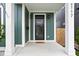 Inviting covered porch showcasing modern design, a welcoming mat, and a stylish green door, with house number at 2117 Broadway St, Indianapolis, IN 46202
