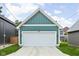 Detached garage with a white door, ample parking, and well-maintained exterior at 2117 Broadway St, Indianapolis, IN 46202